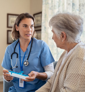 caretaker and elderly woman smiling