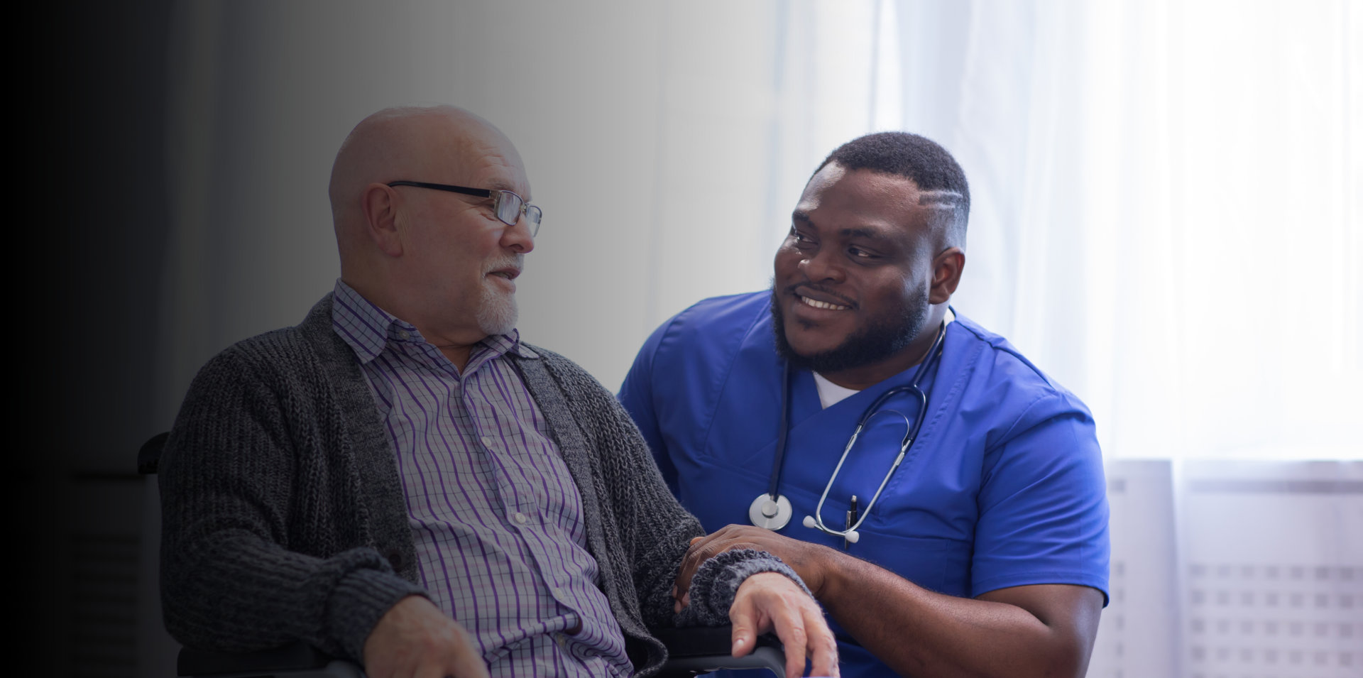 nurse assisting the elderly man