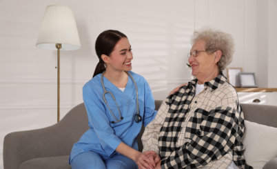 aide and senior woman smiling