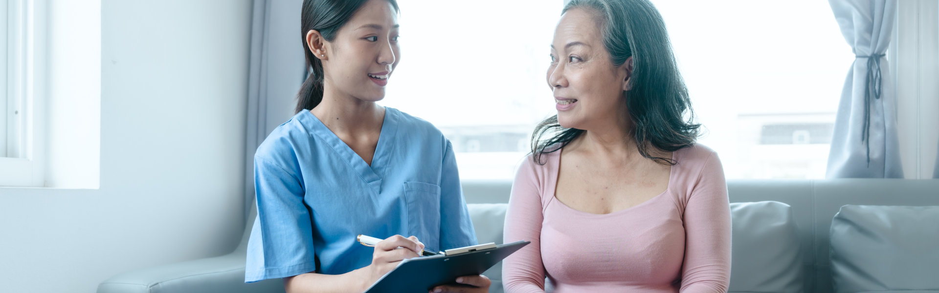 aide and senior woman having a conversation