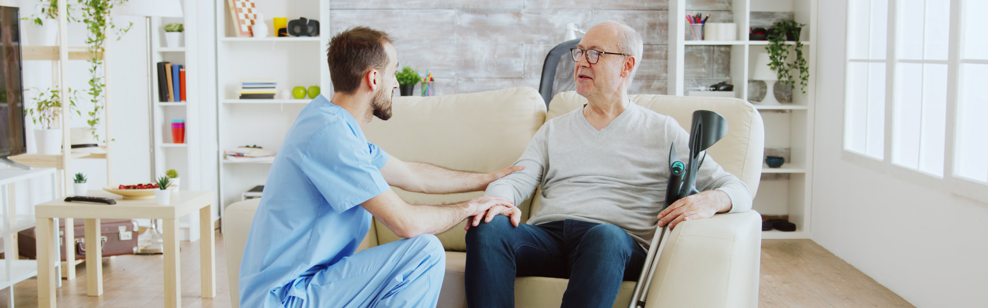 aide and senior man having a conversation