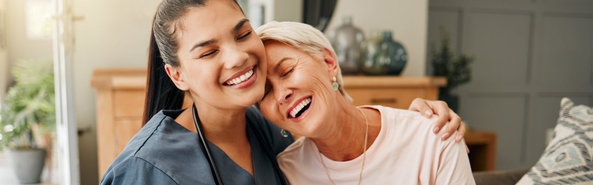 aide and senior woman smiling