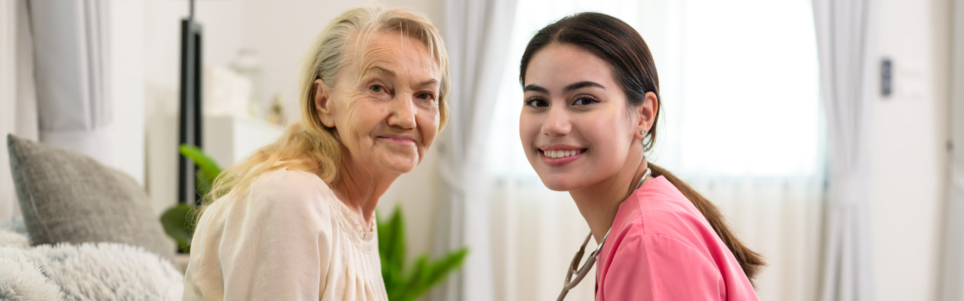 aide and senior woman smiling